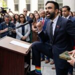Texas Plan to DEPORT Political Opponents… A speaker at a podium passionately addressing a crowd, wearing rainbow socks