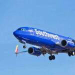 Jet Engine TEARS AWAY: Terrifying Crash Footage! Jet aircraft in flight against clear blue sky.