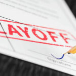 HUGE Layoff: Workers Swapped For Machines—8,000 OUT… Layoff notice being signed with a pen.