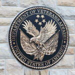 Department of Veterans Affairs seal on a stone wall.
