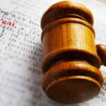 Court Clerk’s Whisper SHOCKS Legal World Gavel on book page highlighting the word legal.