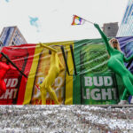 Pride Outbreak PANIC? Boston’s Bold Vaccine Blitz… Parade performers in rainbow bodysuits dancing on a float