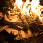 DOT Chief Films Reality Show—GUESS Who’s Footing The Bill?! Burning stack of money in flames