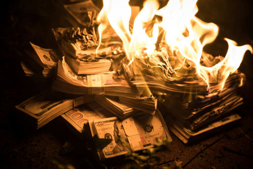 shutterstock_1251353494 (1).jpg Burning stack of money in flames