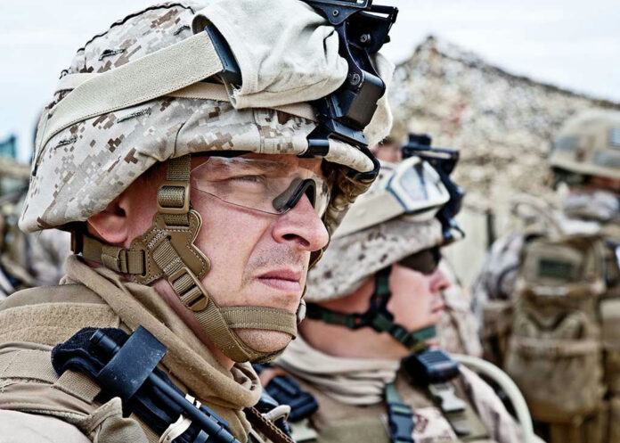 147102638 Soldiers in camouflage uniforms and helmets on duty.