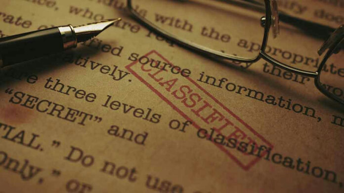 1948471972 Classified document with pen and glasses.