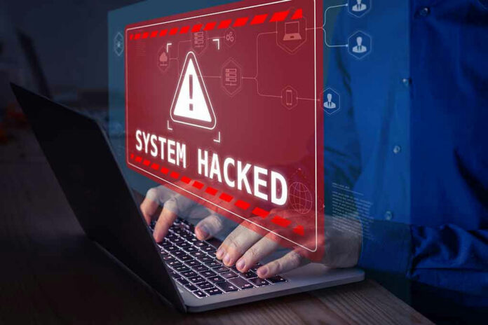 2100631906 System Hacked warning on laptop screen.