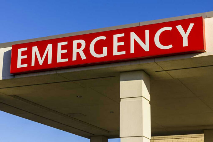 545172235-1 Red and white Emergency sign outside building.