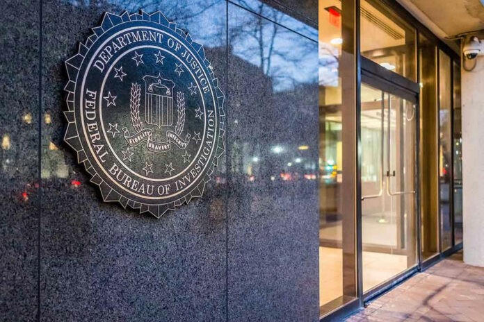555190222 FBI seal on building wall near entrance doors.