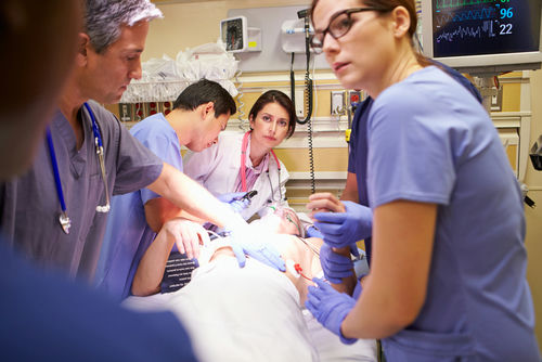 shutterstock_168769280 Medical team working on patient in hospital emergency room.