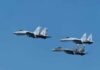 Blue Angel’s Terrifying Pass – Beachgoers Duck, Tents Fly Four fighter jets flying in formation against a clear blue sky