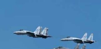 Four fighter jets flying in formation against a clear blue sky