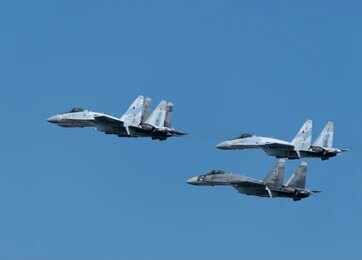 2627579185 Four fighter jets flying in formation against a clear blue sky