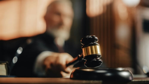 shutterstock2056414424-1jpg Judge's gavel striking sounding block in courtroom