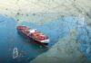 China in Crosshairs Over Putin Oil Container ship at sea under a digital security network overlay