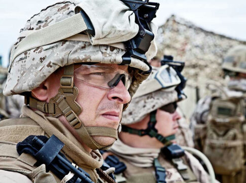 Soldiers in camouflage uniforms and helmets on duty.
