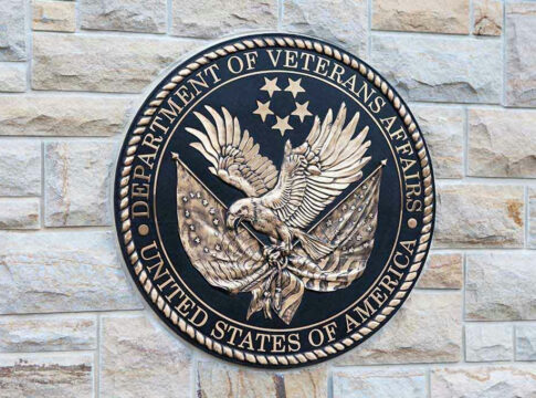 Department of Veterans Affairs seal on a stone wall.