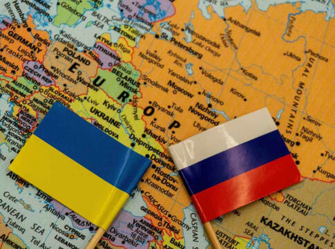 Ukrainian and Russian flags on map of Europe.