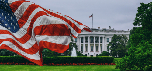 U.S. flag waving in front of the White House.