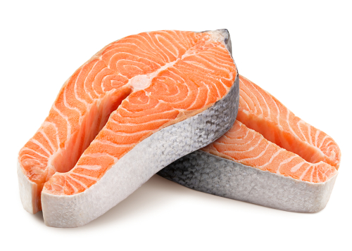 Two raw salmon steaks on a white background.