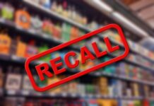 "Recall sign over blurred grocery store shelves."