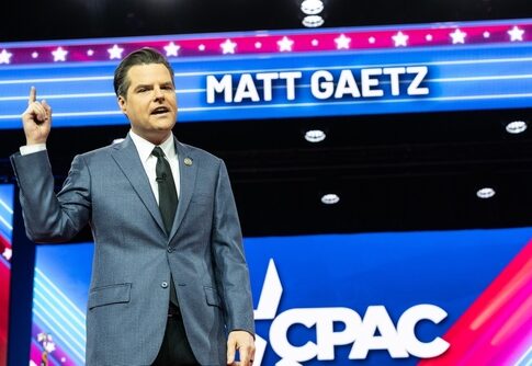 Matt Gaetz speaking at CPAC in front of sign.